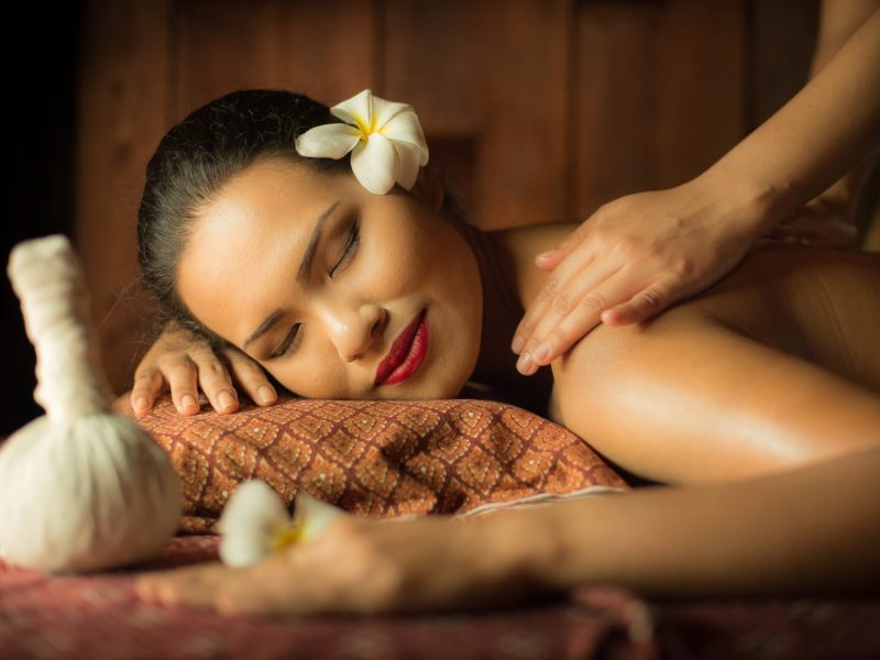 Masseur doing massage on Asian woman body in the spa salon